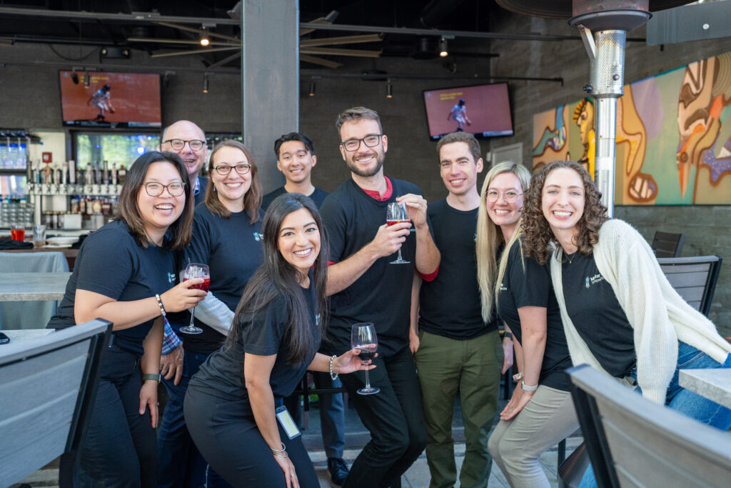 Mediar team members in group shot with drinks