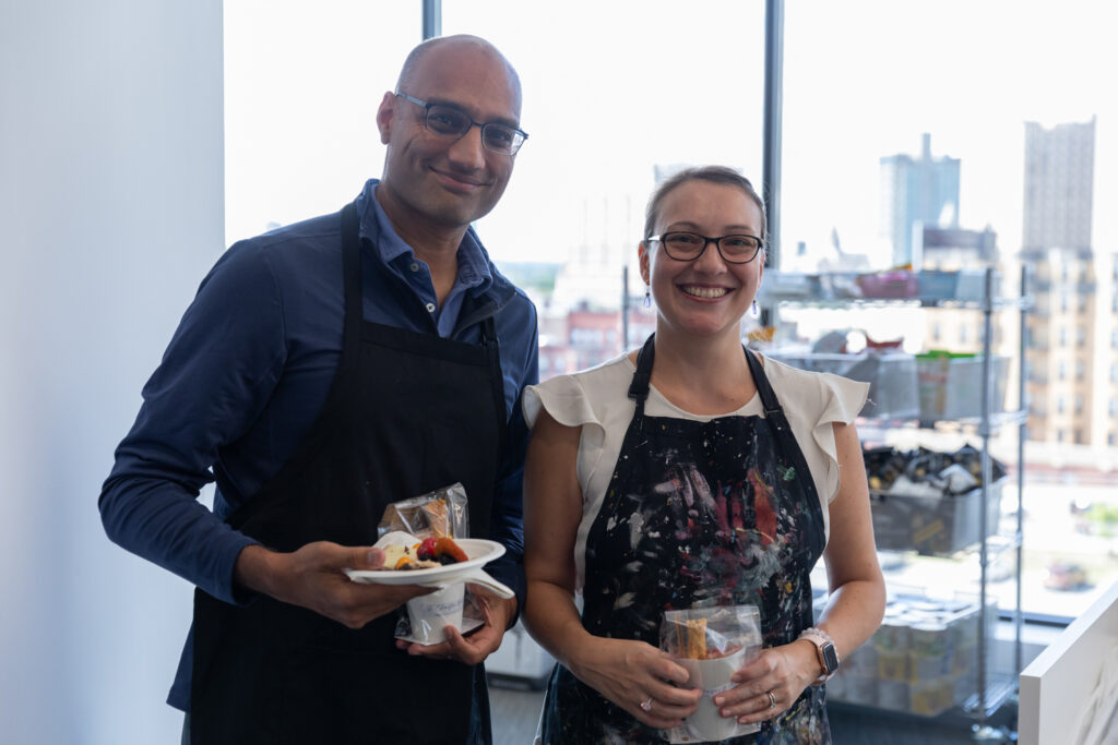 Mediar team members in painting aprons smiling at camera