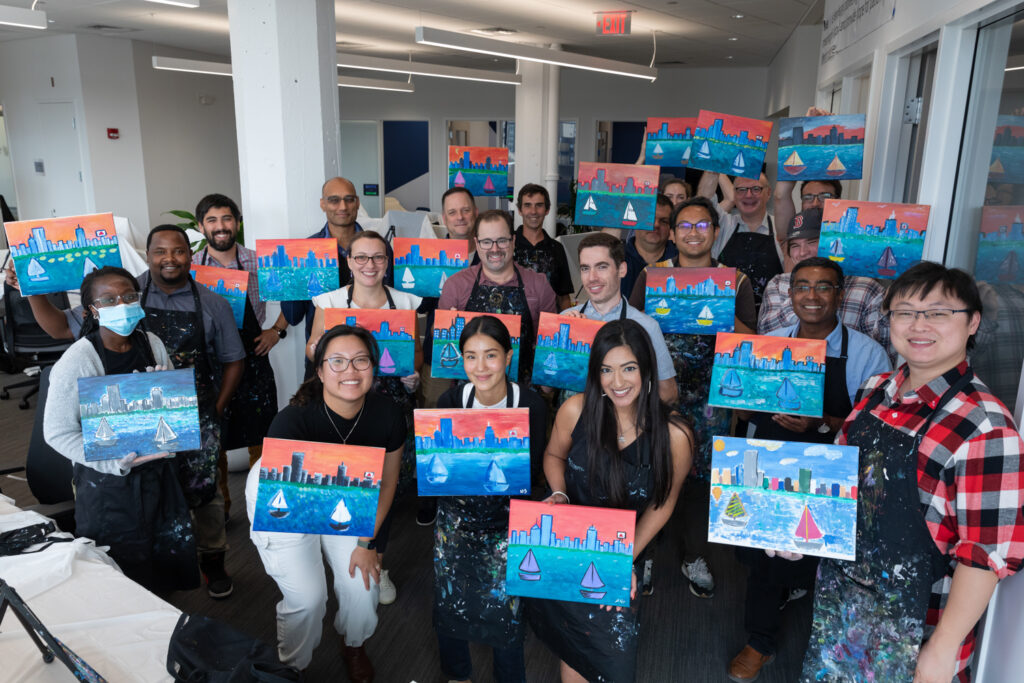 Mediar team members in group shot with paintings